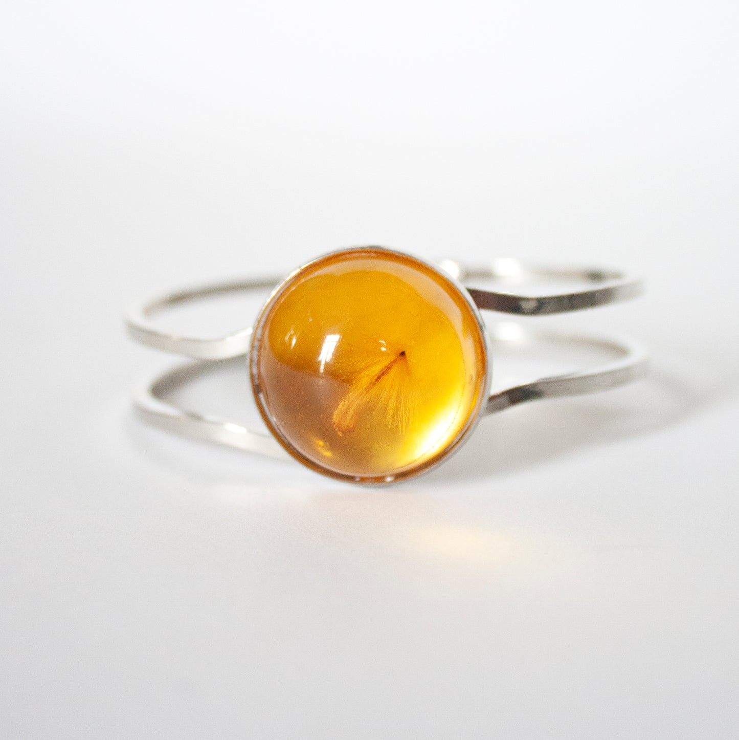 BRACELET WITH A FLYING SEED INSIDE AMBER RESIN.