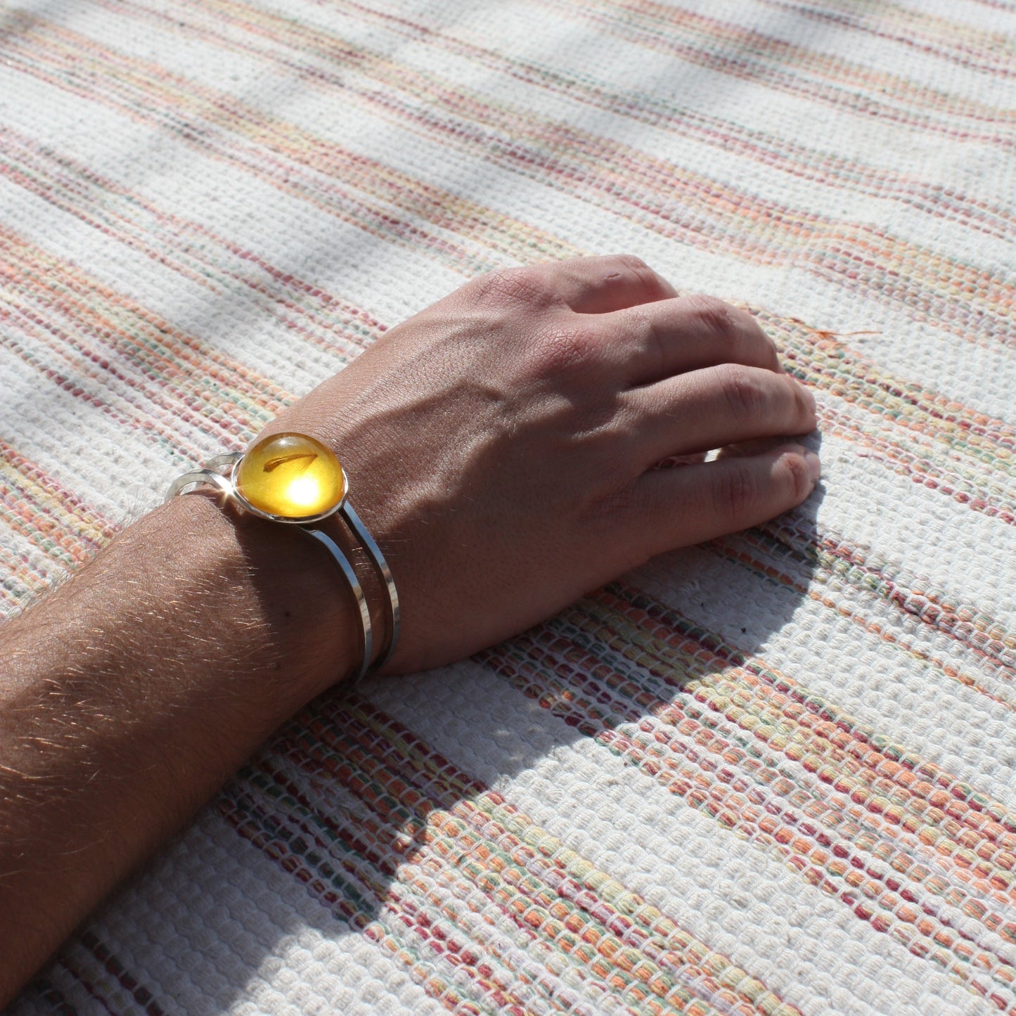 BRACELET WITH A FLYING SEED INSIDE AMBER RESIN.