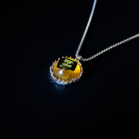 PENDANT WITH A MEMORY CARD AND FILE IN AMBER RESIN. (DO NOT OPEN!)