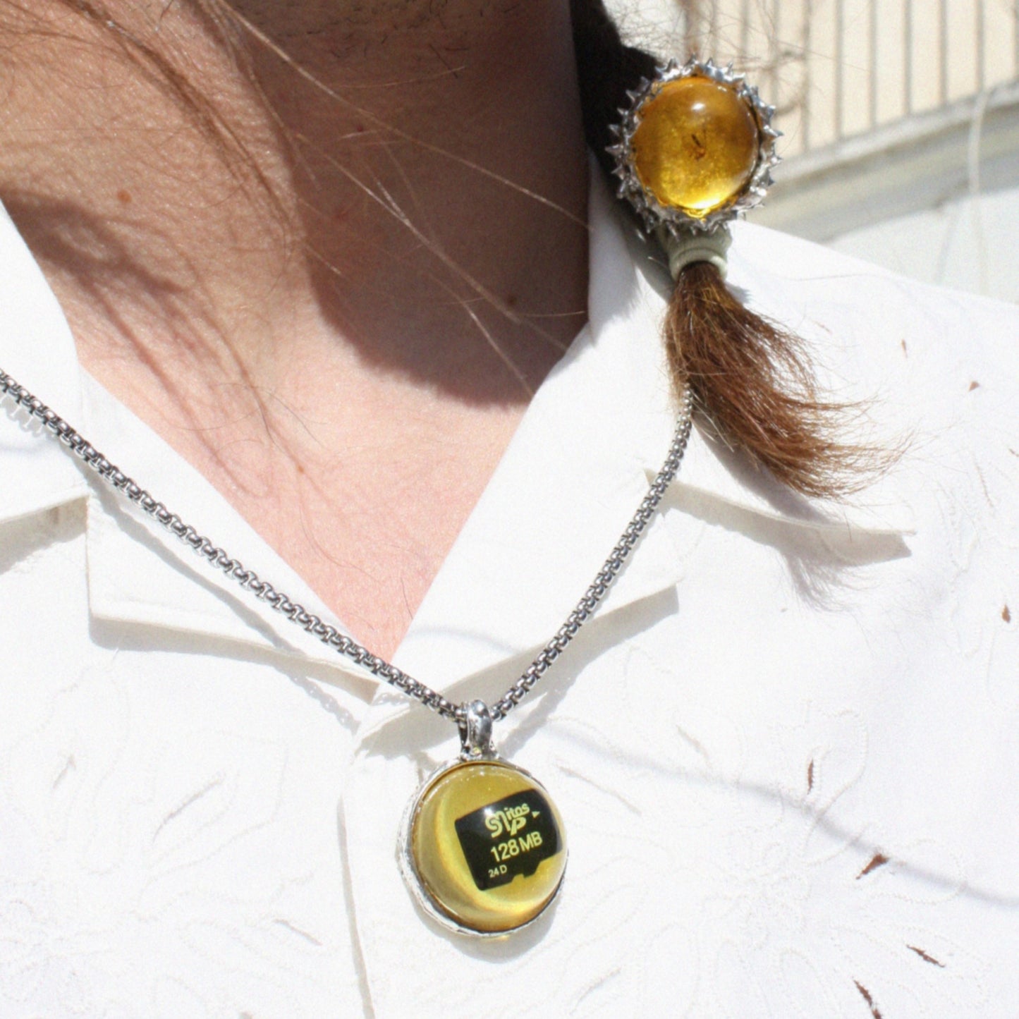 PENDANT WITH A MEMORY CARD AND FILE IN AMBER RESIN. (DO NOT OPEN!)