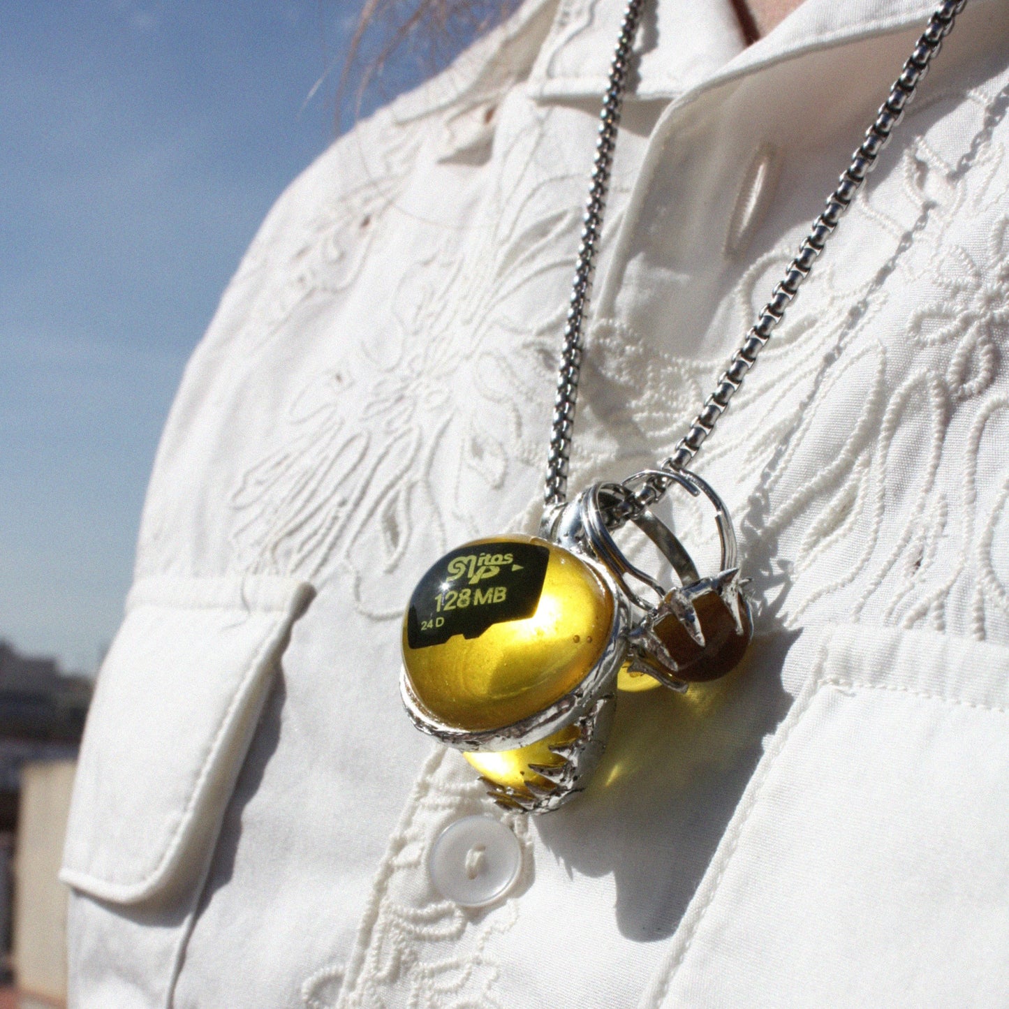 PENDANT WITH A MEMORY CARD AND FILE IN AMBER RESIN. (DO NOT OPEN!)